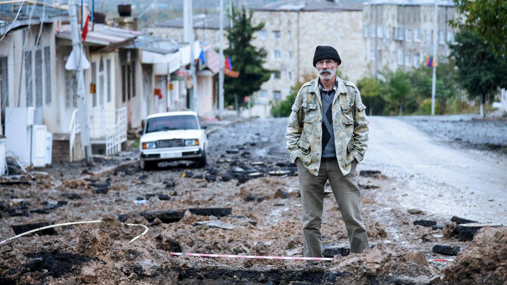 A man stands in a street damaged by shelling of Azerbaijan&#039;s artillery in Stepanakert, the self-proclaimed Republic of Nagorno-Karabakh, Azerbaijan, Tuesday, Oct. 6, 2020. (David Ghahramanyan/NKR InfoCenter PAN Photo via AP)
