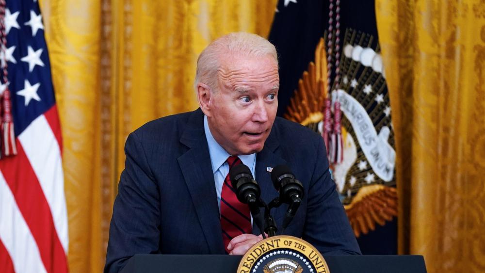 President Joe Biden whispers into the mic in the East Room of the White House, June 24, 2021, in Washington. (AP Photo/Evan Vucci)