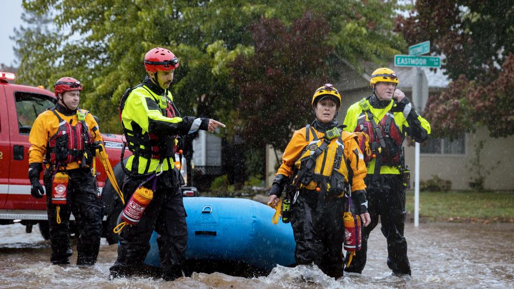 Santa Rosa firefighters check for residents trapped by floodwaters on Neotomas Avenue in Santa Rosa, Calif., on Oct. 24, 2021. (AP Photo/Ethan Swope)