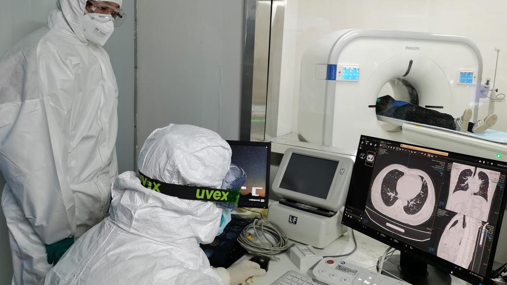 Doctors in China scan a patient&#039;s lungs at Huoshenshan temporary hospital built for patients diagnosed with coronavirus in Wuhan in central China&#039;s Hubei province (Gao Xiang/Xinhua via AP)