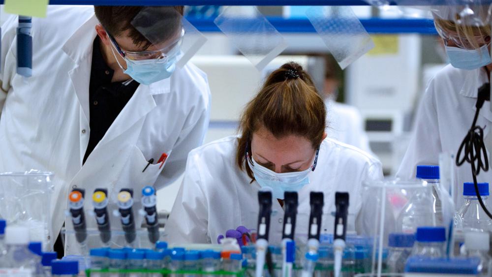 Lab technicians working on a coronavirus vaccine at Johnson &amp; Johnson subsidiary Janssen Pharmaceutical in Beerse, Belgium, June 17, 2020. (AP Photo/Virginia Mayo)