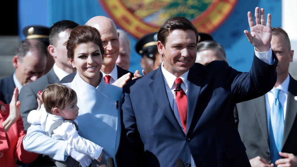 Florida Governor Ron DeSantis waves during an inauguration ceremony with his wife Casey and son Mason, Jan. 8, 2019, in Tallahassee, FL (AP Photo/Lynne Sladky)