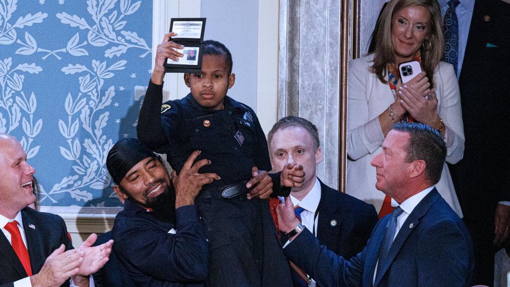 Cancer survivor Devarjaye &quot;DJ&quot; Daniel is applauded as President Donald J. Trump delivers his address to a joint session of the US Congress in the US Capitol, March 4, 2025. (Photo by: Aaron Schwartz/picture-alliance/dpa/AP Images)