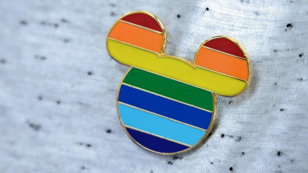 A Disney cast member displays a Mickey Mouse pin on his shirt at The Center, an LGBTQ support organization, while participating in an employee walkout of Walt Disney World, March 22, 2022, in Orlando, FL. (AP Photo/Phelan M. Ebenhack)