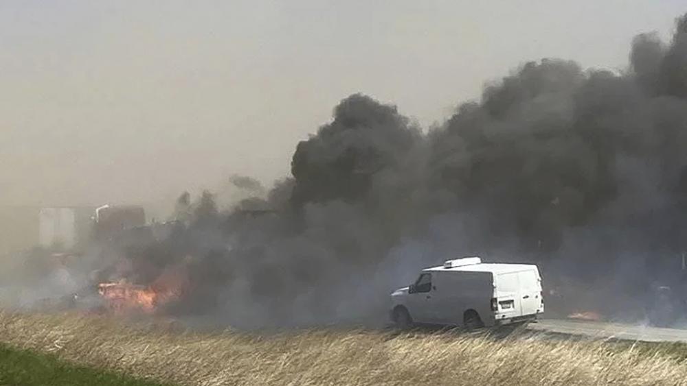 Smoke billows after a crash involving dozens of vehicles during a dust storm shut down a highway in Illinois, Monday, May 1, 2023. (WICS TV via AP)