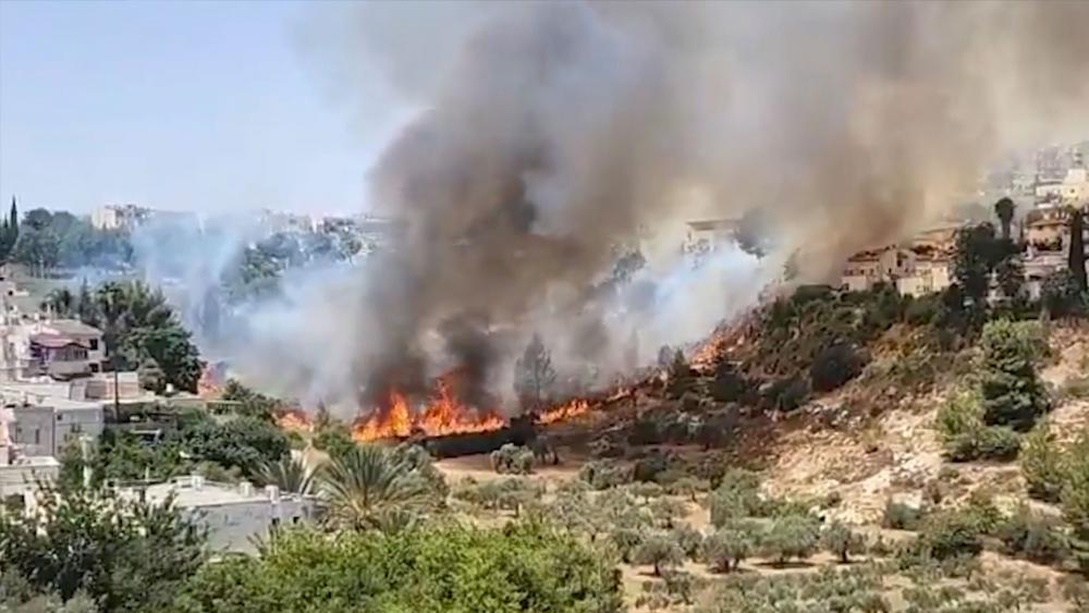 Fires in northern Israel were caused by a massive rocket attack from Hezbollah in Lebanon.