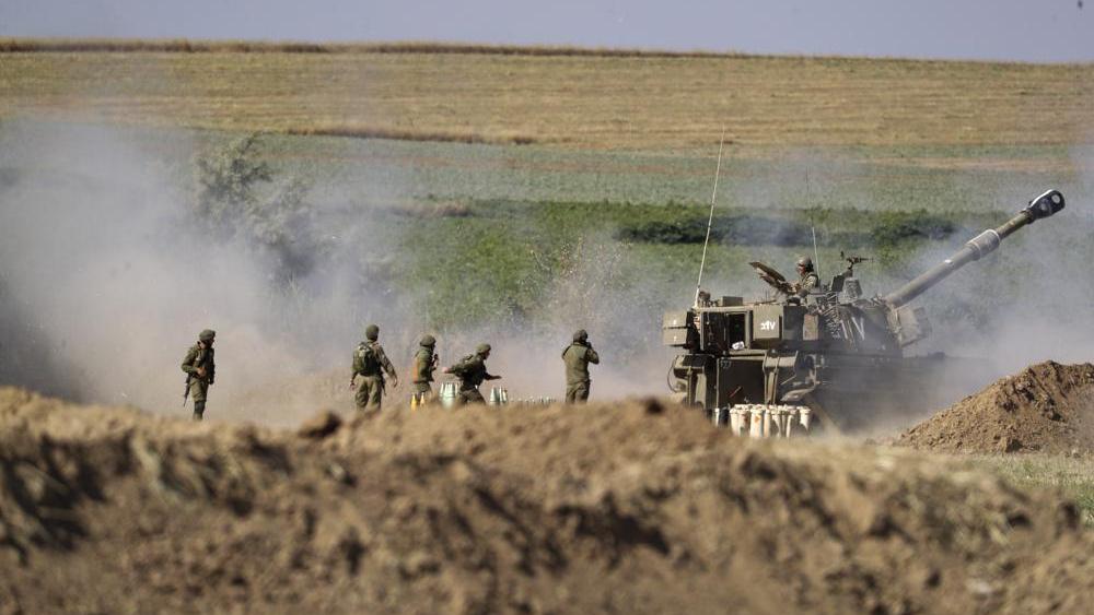 An Israeli artillery unit fires toward targets in Gaza Strip, at the Israeli Gaza border, Saturday, May 15, 2021. (AP Photo/Ariel Schalit)