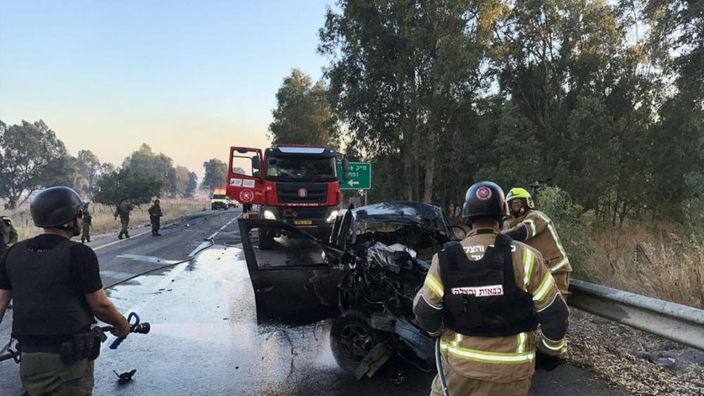 First responders arrive at the scene of a rocket attack that hit a car in Israel&#039;s North. July 9, 2024. Photo Credit: ISRAEL FIRE AND RESCUE AUTHORITY)