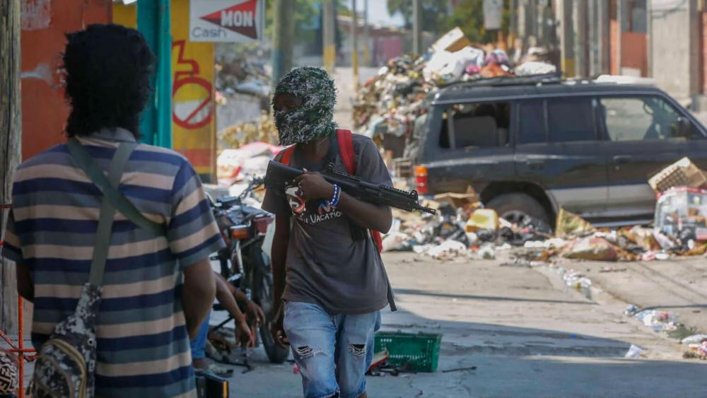 Armed members of the G9 and Family gang stand guard at their roadblock in the Delmas 6 neighborhood of Port-au-Prince, Haiti, March 11, 2024.  .(AP Photo/Odelyn Joseph, File)