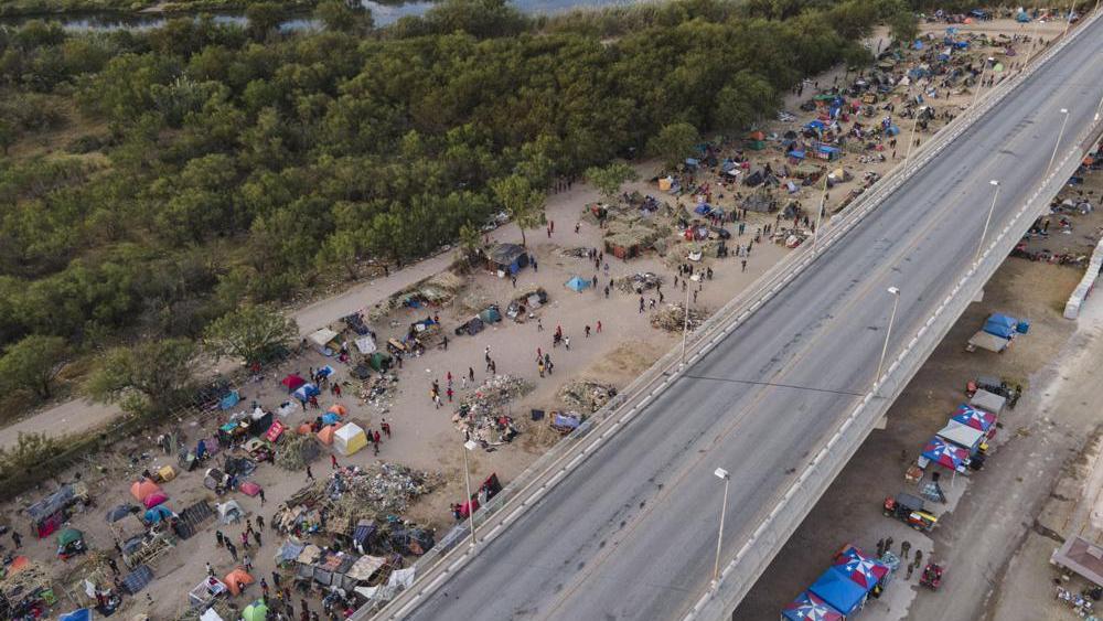 Migrants, many from Haiti, are seen at an encampment along the Del Rio International Bridge, Wednesday, Sept. 22, 2021, in Del Rio, Texas. (AP Photo/Julio Cortez)