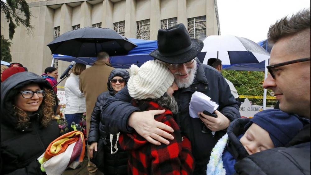 Rabbi Chuck Diamond, center, a former Rabbi at the Tree of Life Synagogue, hugs a woman after leading a Shabbat service outside the Tree of Life Synagogue, Saturday, Nov. 3, 2018 in Pittsburgh. AP Photo. 