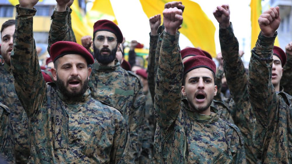 Hezbollah fighters raise their fists after Israel&#039;s military said it killed a senior commander with the jihadist group&#039;s elite Radwan Force (AP Photo/Mohammed Zaatari)