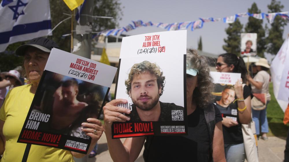 Relatives and supporters of hostages held by Hamas in the Gaza Strip protest outside the prime minister&#039;s office in Jerusalem on Tuesday, July 1, 2025. (AP Photo/Ohad Zwigenberg)