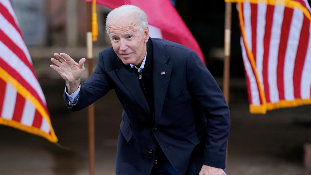 President-elect Joe Biden waves to supporters after speaking at a drive-in rally for Georgia Democratic candidates for U.S. Senate Raphael Warnock and Jon Ossoff, Dec. 15, 2020, in Atlanta. (AP Photo/Patrick Semansky)