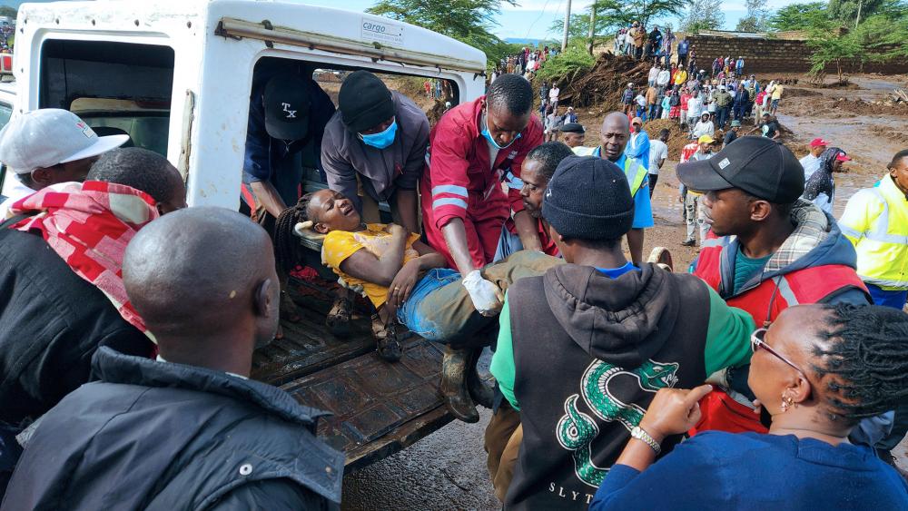 Paramedics carry an injured woman after a river broke through a blocked tunnel causing floodwaters in the Mai Mahiu area of Nakuru County, Kenya, Monday, April. 29, 2024. (AP Photo)