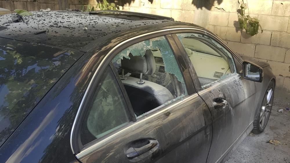 A damaged car after what is believed to be the result of a walkie-talkie exploding inside it, in the city of Sidon, Lebanon, Sept. 18, 2024. (AP Photo/Mohammed Zaatari)