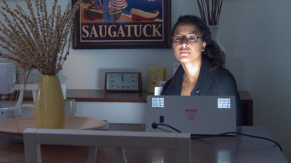 A woman uses light therapy for Seasonal Affective Disorder and the &quot;winter blues&quot;.