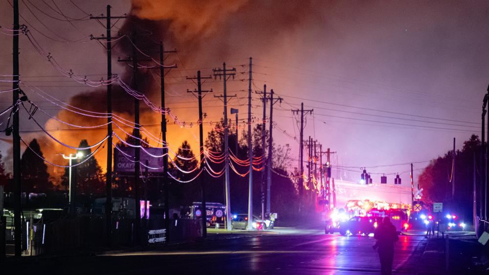 Plums of smoke rise from the area of a UPS cargo plane crash at Louisville Muhammad Ali International Airport, on Tuesday, Nov. 4, 2025, in Louisville, Ky. (AP Photo/Jon Cherry)