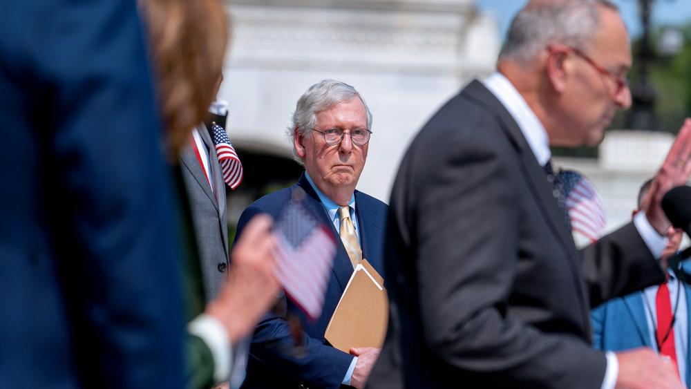 Senate Minority Leader Mitch McConnell looks on as Senate Majority Leader Chuck Schumer speaks (AP Photo/Andrew Harnik)