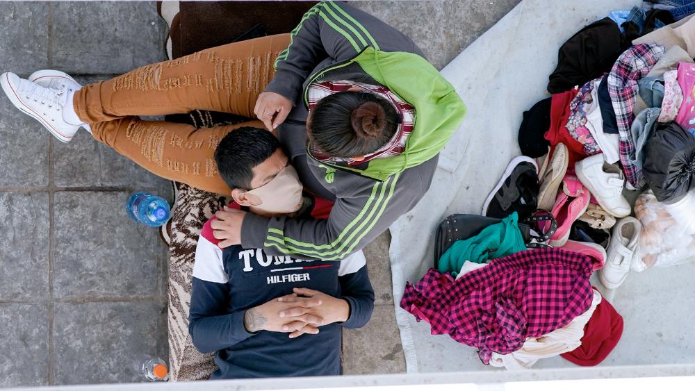 Migrants who were deported after being caught trying to sneak into the U.S. rest under a ramp that leads to the McAllen-Hidalgo International Bridge point of entry into the U.S., March 18, 2021, in Reynosa, Mexico. (AP Photo/Julio Cortez)