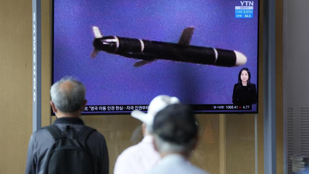 People watch a TV screen showing a news program showing a North Korean handout photo that says, &quot;North Korea&#039;s long-range cruise missiles tests.&quot; (AP Photo/Lee Jin-man)