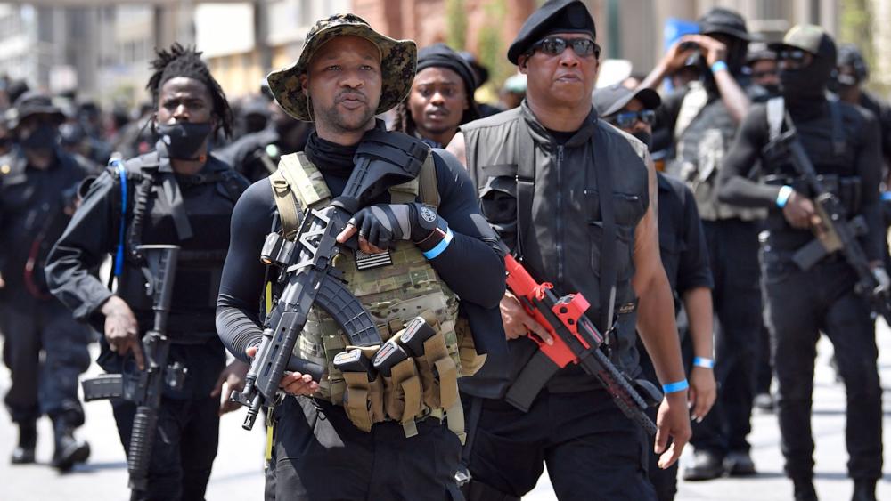 Armed members of the &quot;NFAC&quot; march through Louisville, KY, on July 25, 2020 to demand justice for Breonna Taylor (AP Photo/Timothy D. Easley)