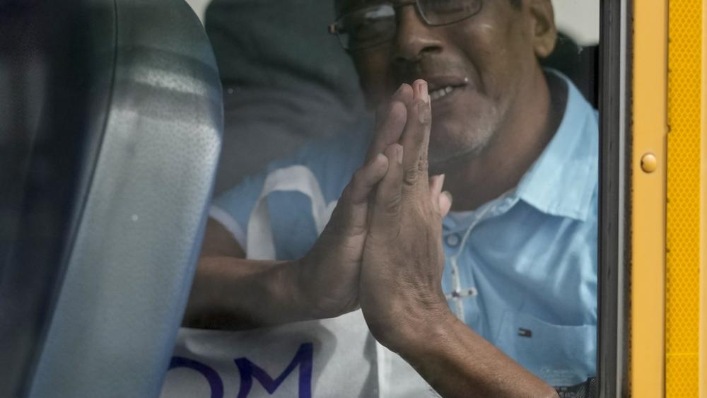 Isaias Ruiz gestures from a bus after being released from a Nicaraguan jail and landing at the airport in Guatemala City, Thursday, Sept. 5, 2024. (AP Photo/Moises Castillo)