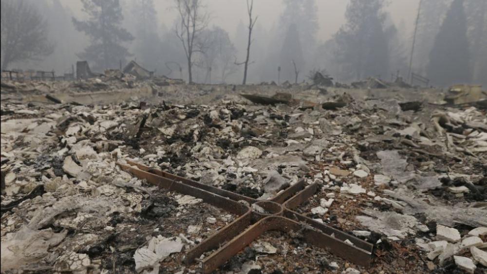 A cross is among the rubble of the Our Savior Lutheran Church Friday, Nov. 9, 2018, in Paradise, Calif. The church was destroyed by a wildfire that swept through the area. (AP Photo)