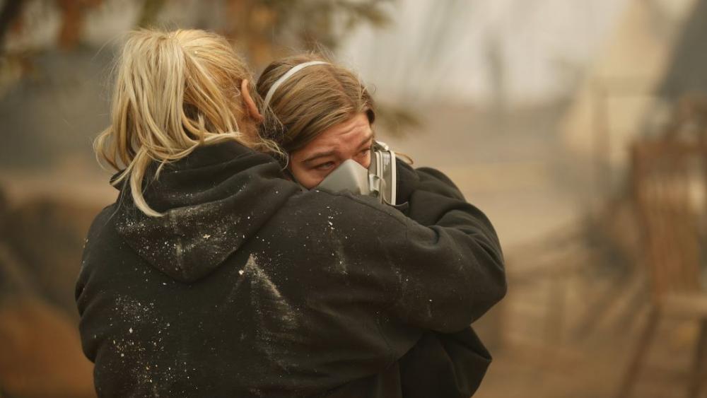 Krystin Harvey, left, comforts her daughter Araya Cipollini at the remains of their home burned in the Camp Fire, Saturday, Nov. 10, 2018, in Paradise, Calif. AP Photo.