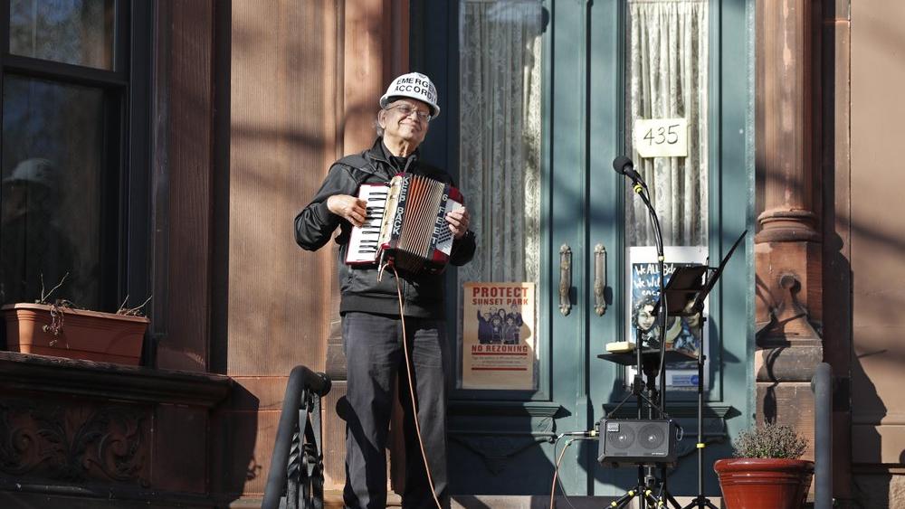 Paul Stein entertains neighbors with an &quot;Emergency Accordion Stoop Extravaganza&quot; (EASE) concert from his stoop (AP Photo/Kathy Willens)