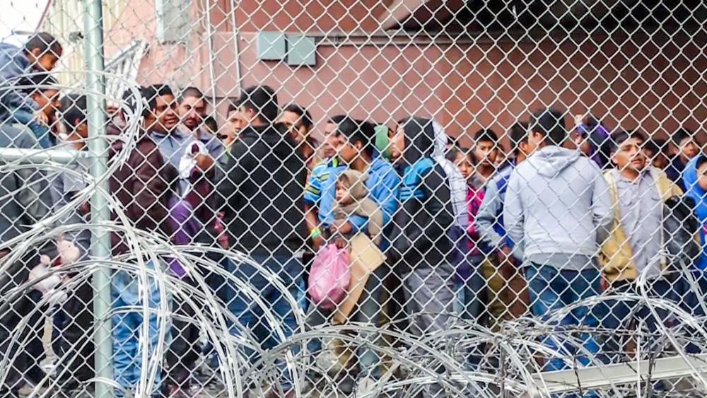 Migrants await processing by the US Border Patrol. (AP Photo)