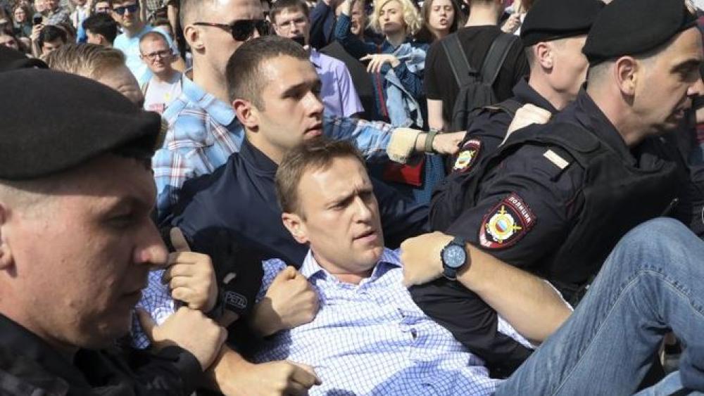 Russian police carry struggling opposition leader Alexi Navalny, center, at a demonstration against President Vladimir Putin in Pushkin Square in Moscow, Russia. 