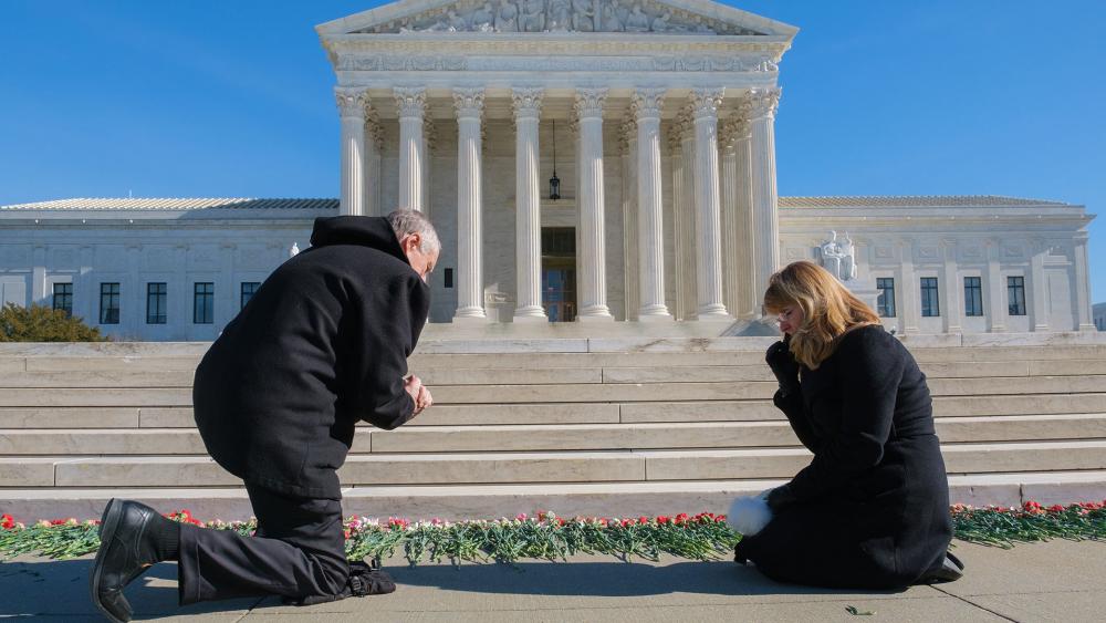 Public lays flowers at US Supreme Court for ‘Remembering the Unborn Memorial’ (Photo Credit: Patrick Robertson)