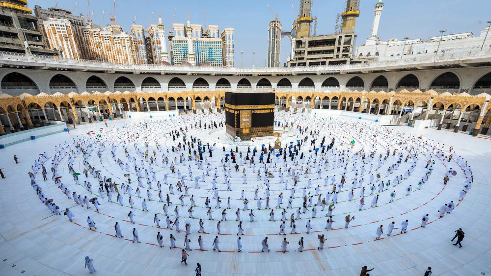 Pilgrims walk around the Kabba at the Grand Mosque, in the Muslim holy city of Mecca, Saudi Arabia, Friday, July 31, 2020.  (Saudi Ministry of Media via AP)