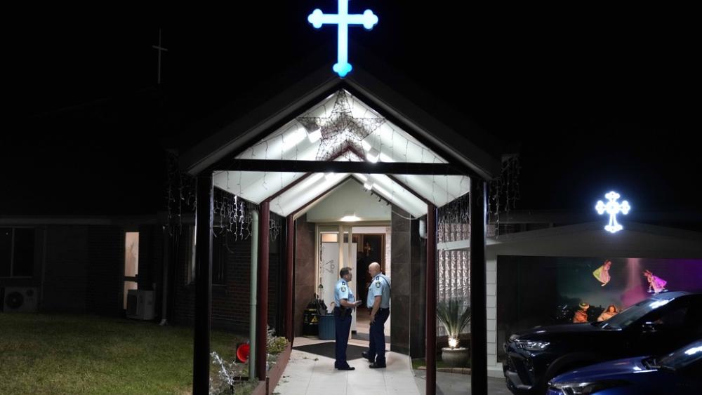 Security officers stand guard outside Orthodox Assyrian church in Sydney, Australia, April 15, 2024. A man has been arrested after a bishop and churchgoers were stabbed in the church. (AP Photo/Mark Baker)