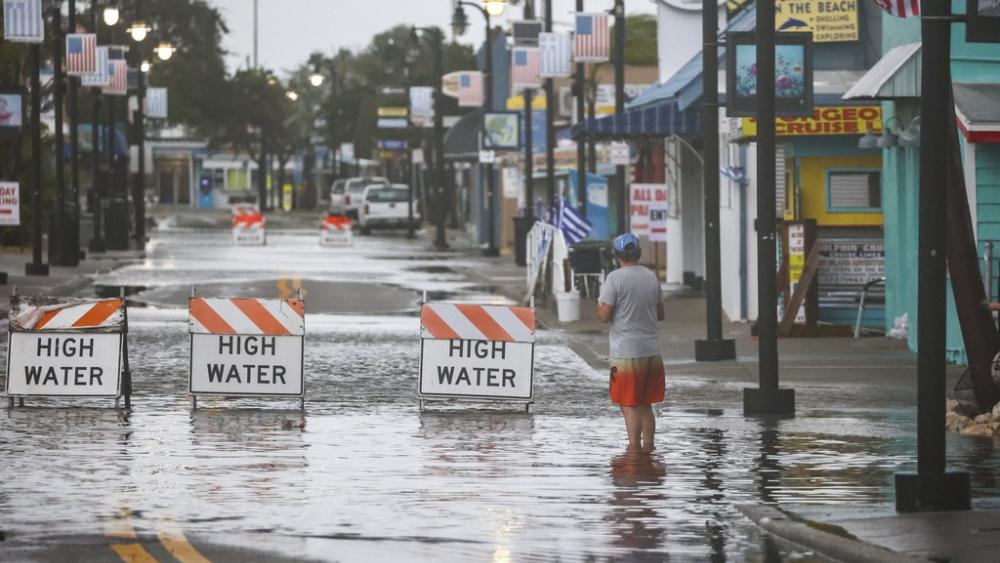 Flood water blocks a section of Dodecanese Blvd at the Tarpon Springs Sponge Docks, Monday morning, Aug 5, 2024, in Tarpon Springs, Fla., as Hurricane Debby passes the Tampa Bay area offshore. (Douglas R. Clifford/Tampa Bay Times via AP)