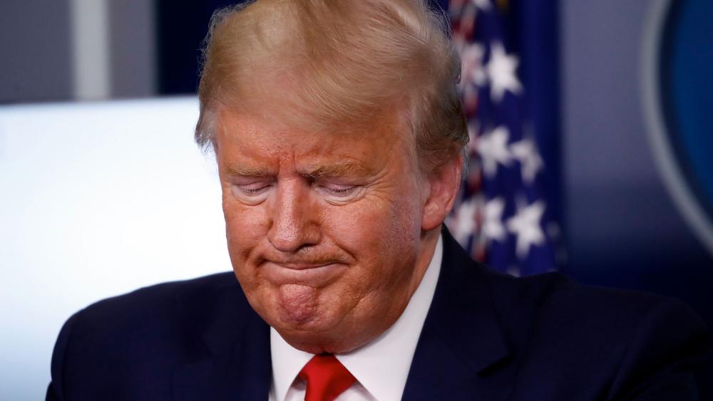 President Donald Trump pauses during a briefing about the coronavirus at the White House. (AP Photo/Alex Brandon)