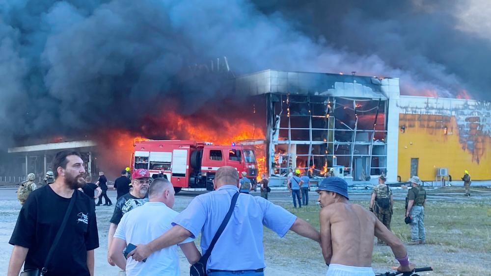 Smoke billows after a Russian missile strike hit a crowded shopping mall, in Kremenchuk, Ukraine, Monday, June 27, 2022. (Viacheslav Priadko via AP)