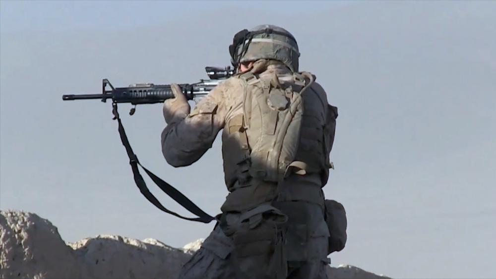 Soldier firing rifle