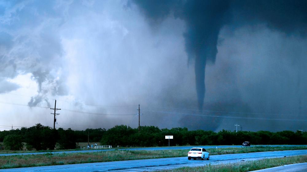 A tornado spins west of Hawley, Texas, as cars pass on U.S. 277 on Thursday May 2, 2024. (Ronald W. Erdrich/The Abilene Reporter-News via AP)