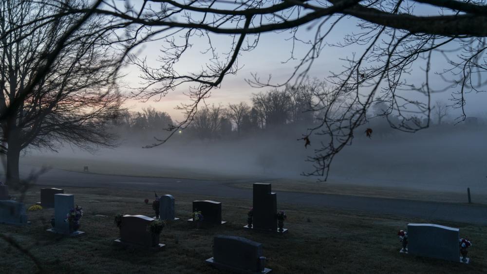  In this Wednesday, March 17, 2021 file photo, morning fog blankets a cemetery in West Virginia. (AP Photo/David Goldman) 