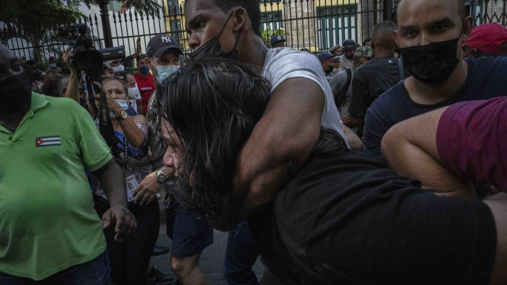 Plainclothes police detain an anti-government protester during a protest in Havana, Cuba, Sunday, July 11, 2021.(AP Photo/Ramon Espinosa)