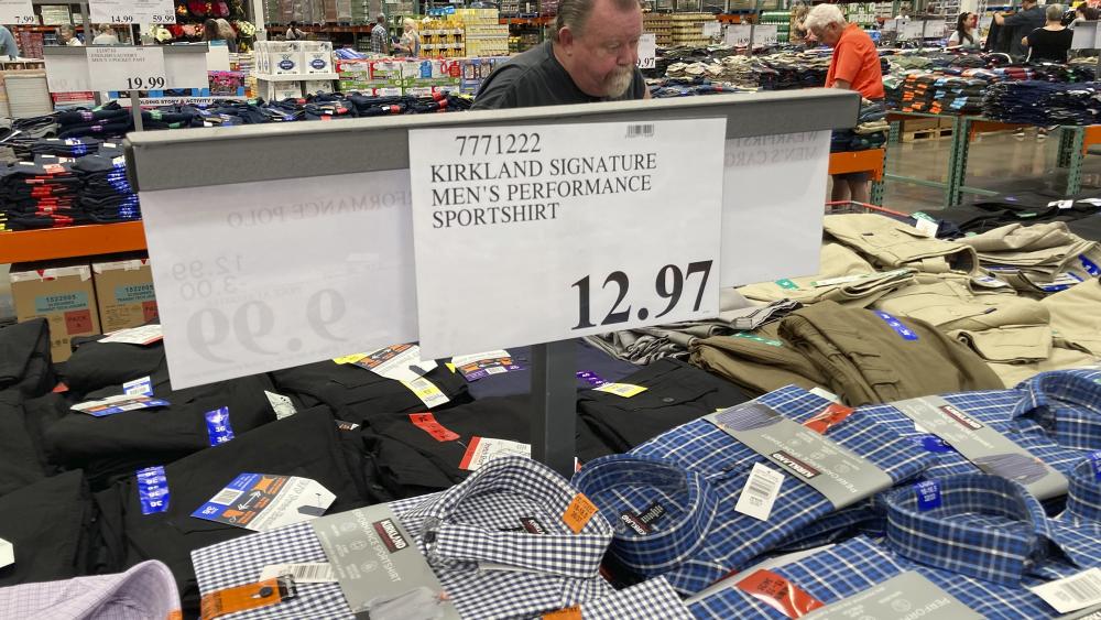 A sign displays the price for shirts as a shopper peruses the offerings at a Costco warehouse on Thursday, June 17, 2021, in Lone Tree, Colo. (AP Photo/David Zalubowski) 