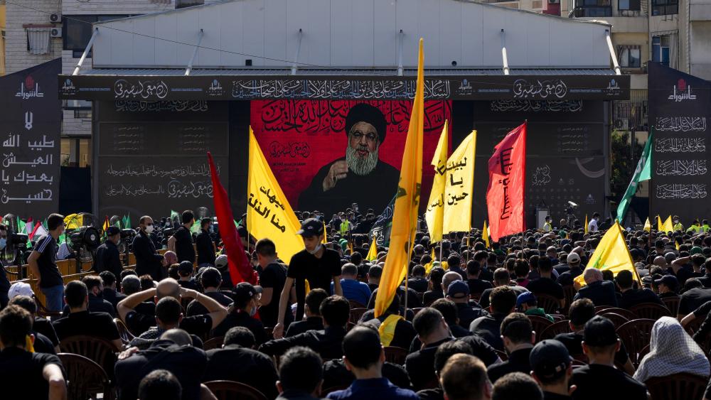 Hezbollah supporters listen to their leader Sayyed Hassan Nasrallah as he speaks via a video link in southern Beirut, Lebanon, Thursday, Aug. 19, 2021. (AP Photo/ Hassan Ammar)
