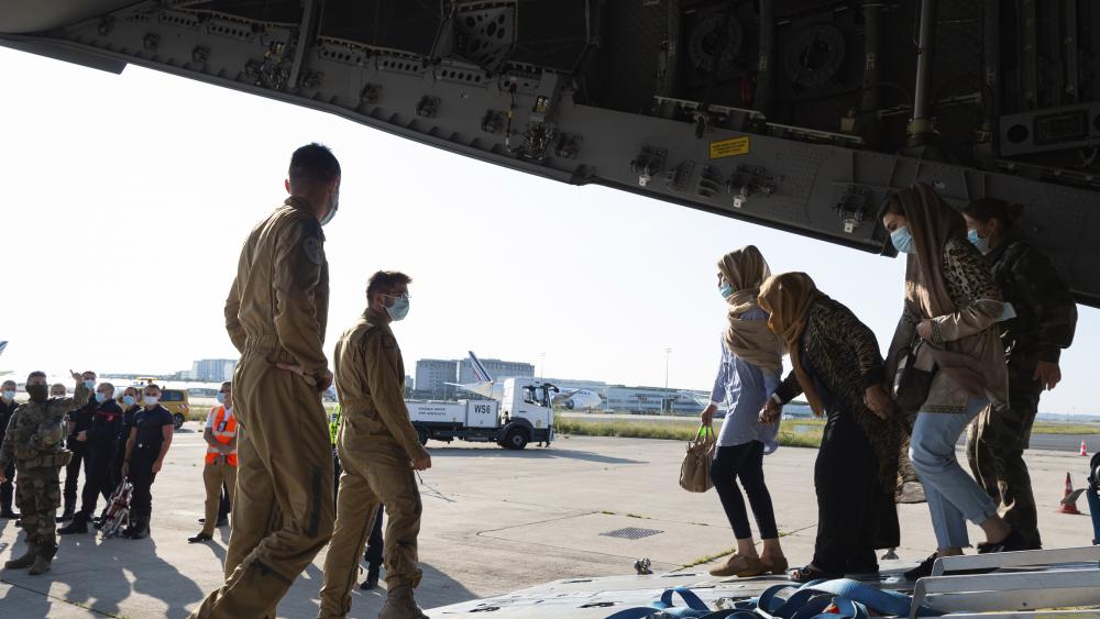 This photo provided by the French Army Thursday, Aug.26, 2021 shows Afghan refugees arriving in a military plane at Roissy airport, north of Paris, Wednesday, Aug.25, 2021. (Eric Cadiou/Etat Major des Armees via AP)