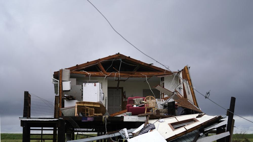 Storm clouds from Tropical Storm Nicholas are seen behind a home that was destroyed by Hurricane Ida, in Pointe-aux-Chenes, La., Tuesday, Sept. 14, 2021. (AP Photo/Gerald Herbert)
