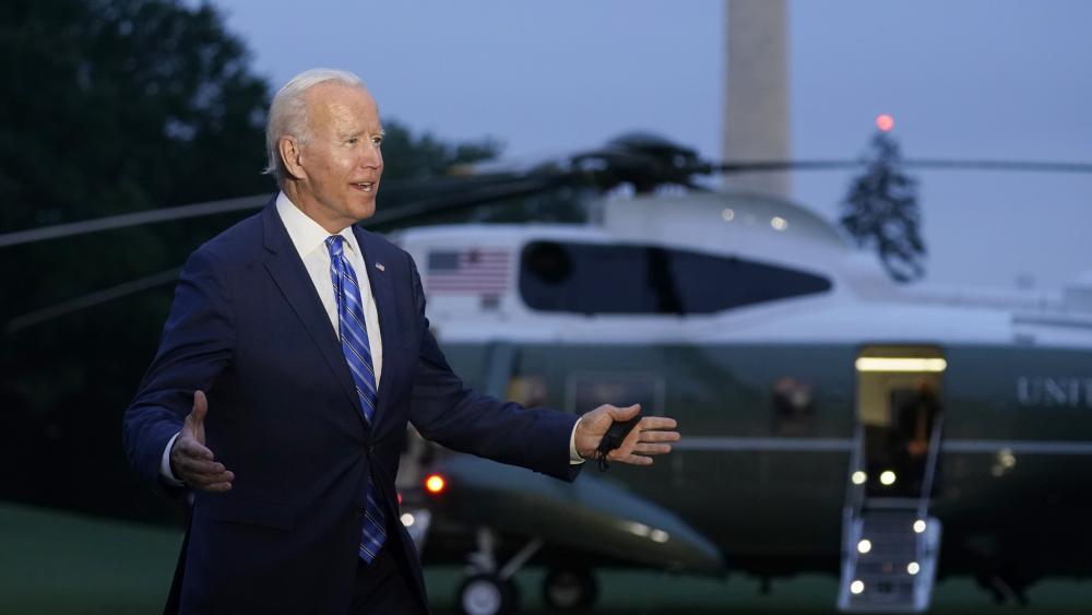 President Joe Biden talks with reporters after returning to the White House in Washington, Tuesday, Oct. 5, 2021, after a trip to Michigan to promote his infrastructure plan. (AP Photo/Susan Walsh)