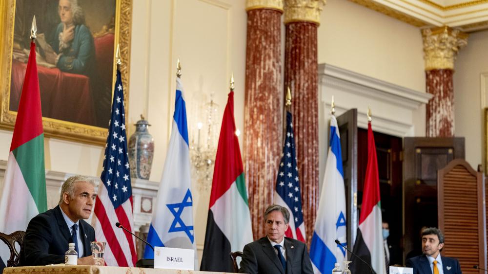 Israeli Foreign Minister Yair Lapid, left, accompanied by Secretary of State Antony Blinken, right, speaks at a joint news conference at the State Department in Washington, Wednesday, Oct. 13, 2021. (AP Photo/Andrew Harnik, Pool)