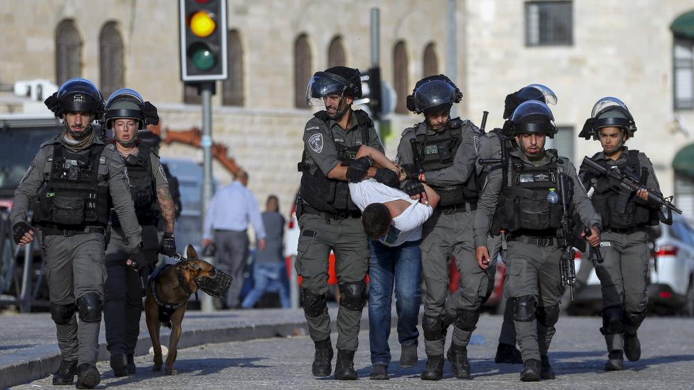Israeli border police officers detain a Palestinian youth during clashes between Palestinians and Israeli police as thousands of Muslims flocked to Jerusalem&#039;s Old City to celebrate the Prophet Muhammad&#039;s birthday, Tuesday, Oct. 19, 2021. (AP Photo/Mahmou
