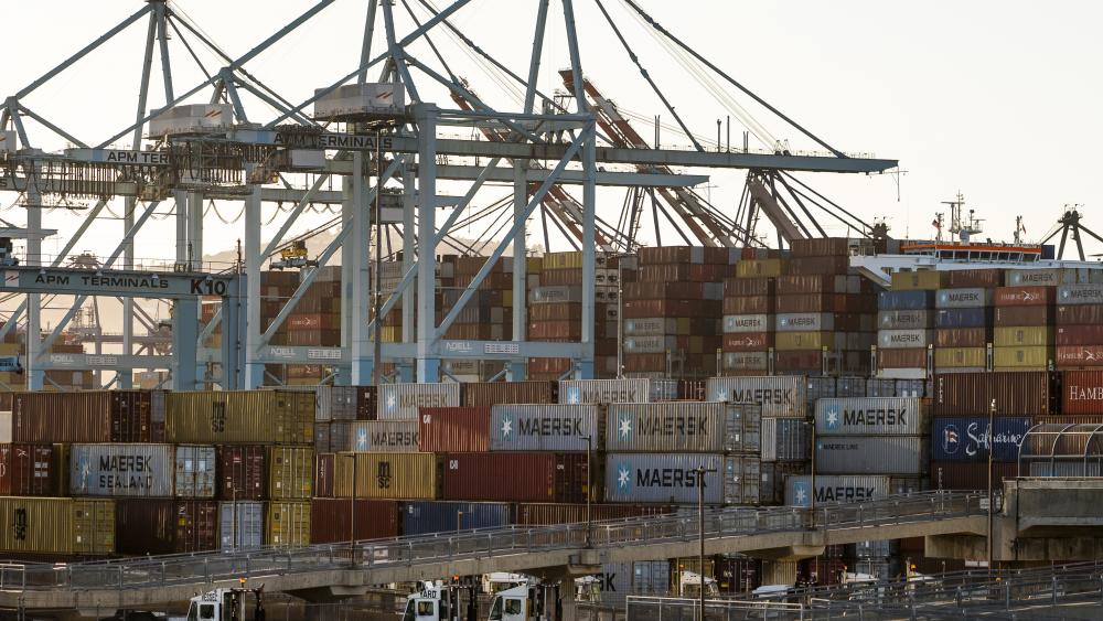 In this Tuesday, Oct. 19, 2021, photo shipping containers are stacked up at Maersk APM Terminals Pacific at the Port of Los Angeles. (AP Photo/Damian Dovarganes)